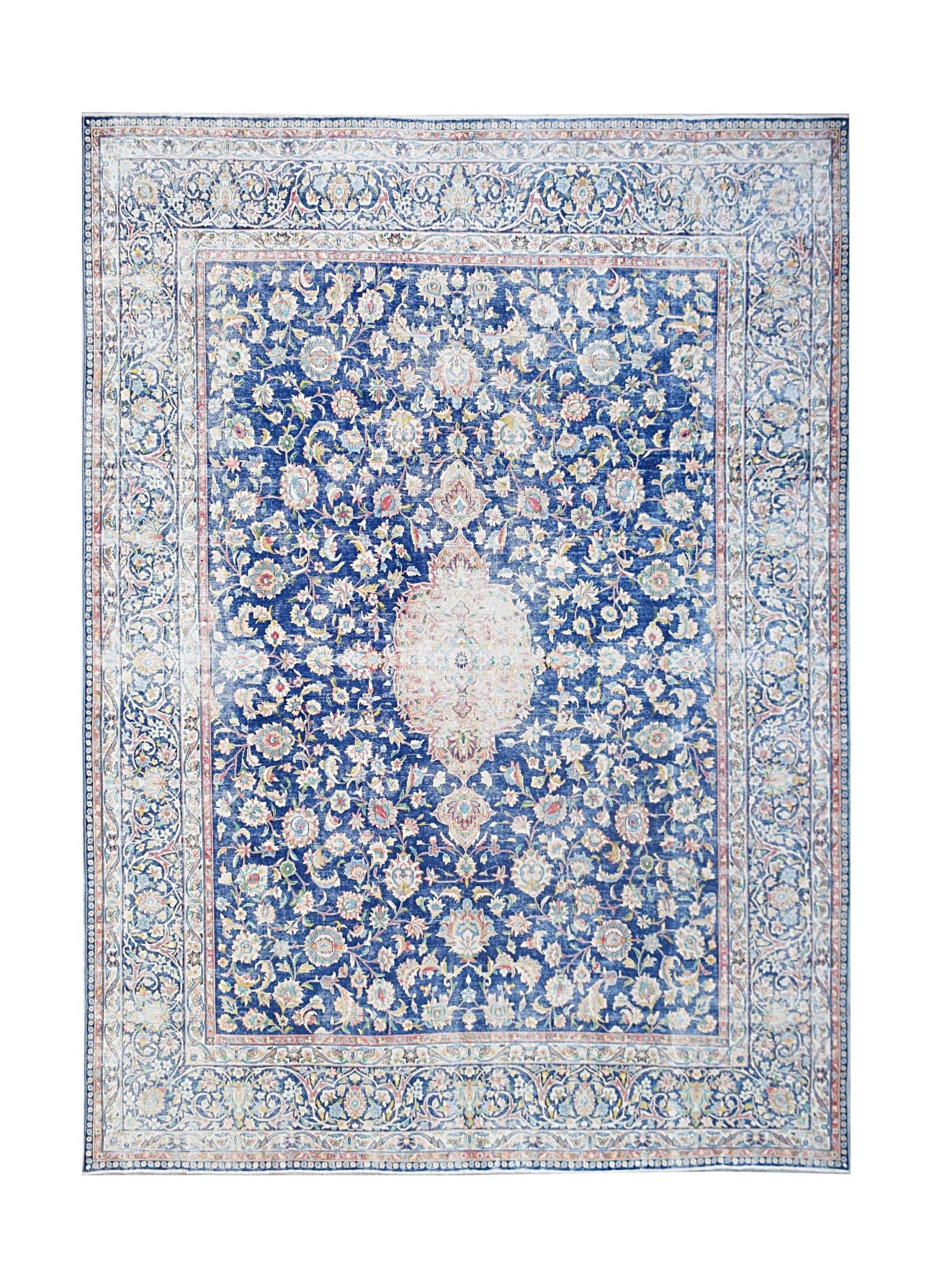 A vintage Persian Kerman rug featuring a central medallion and intricate blue floral patterns.