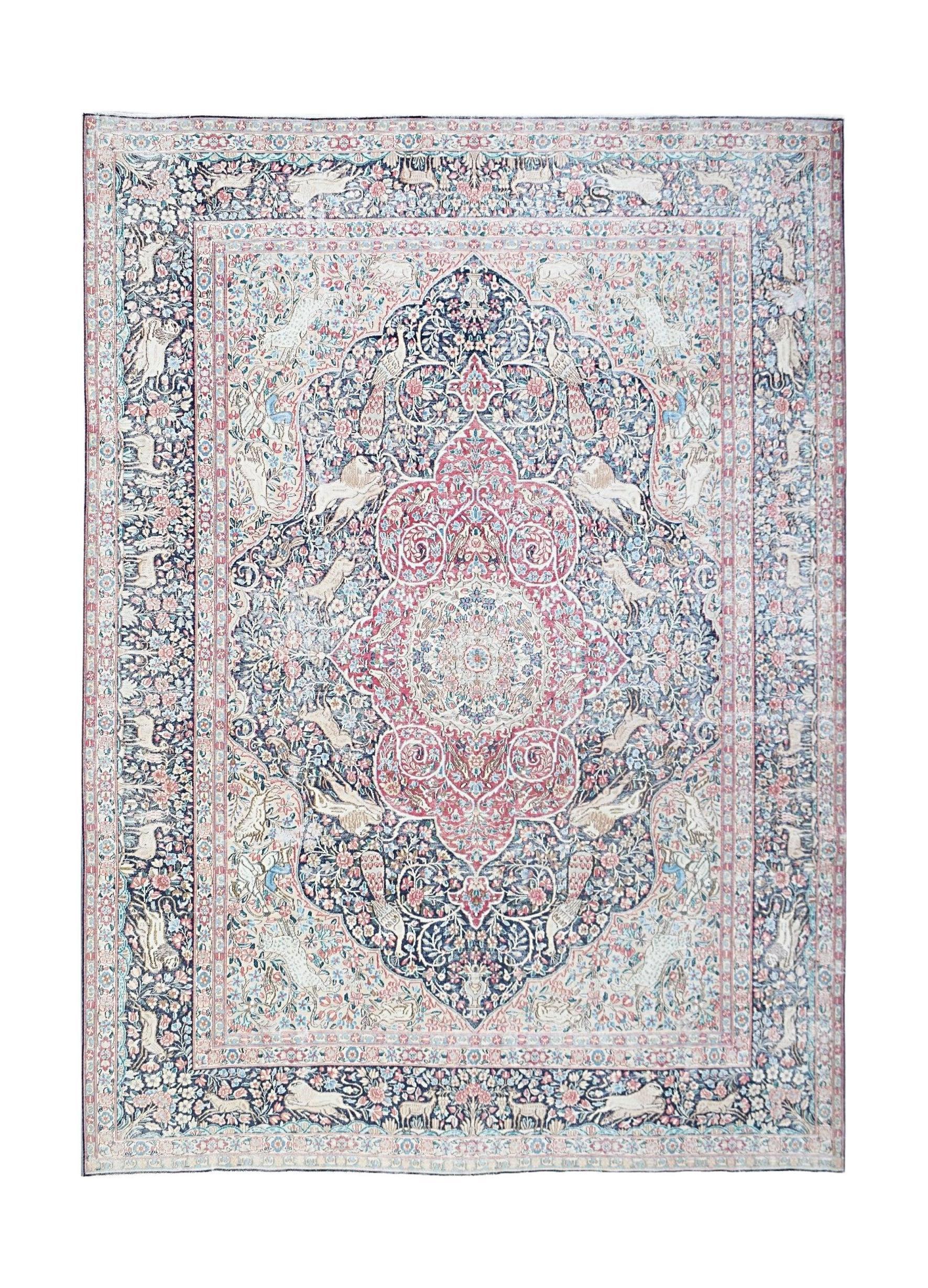 Vintage Persian Kerman rug featuring an intricate floral medallion design in soft pink and blue.