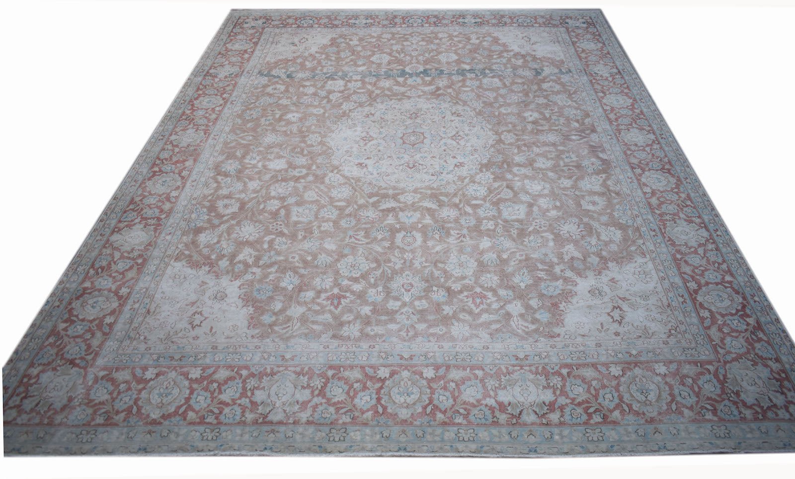 A vintage Persian Kerman rug featuring a central medallion and intricate floral patterns.