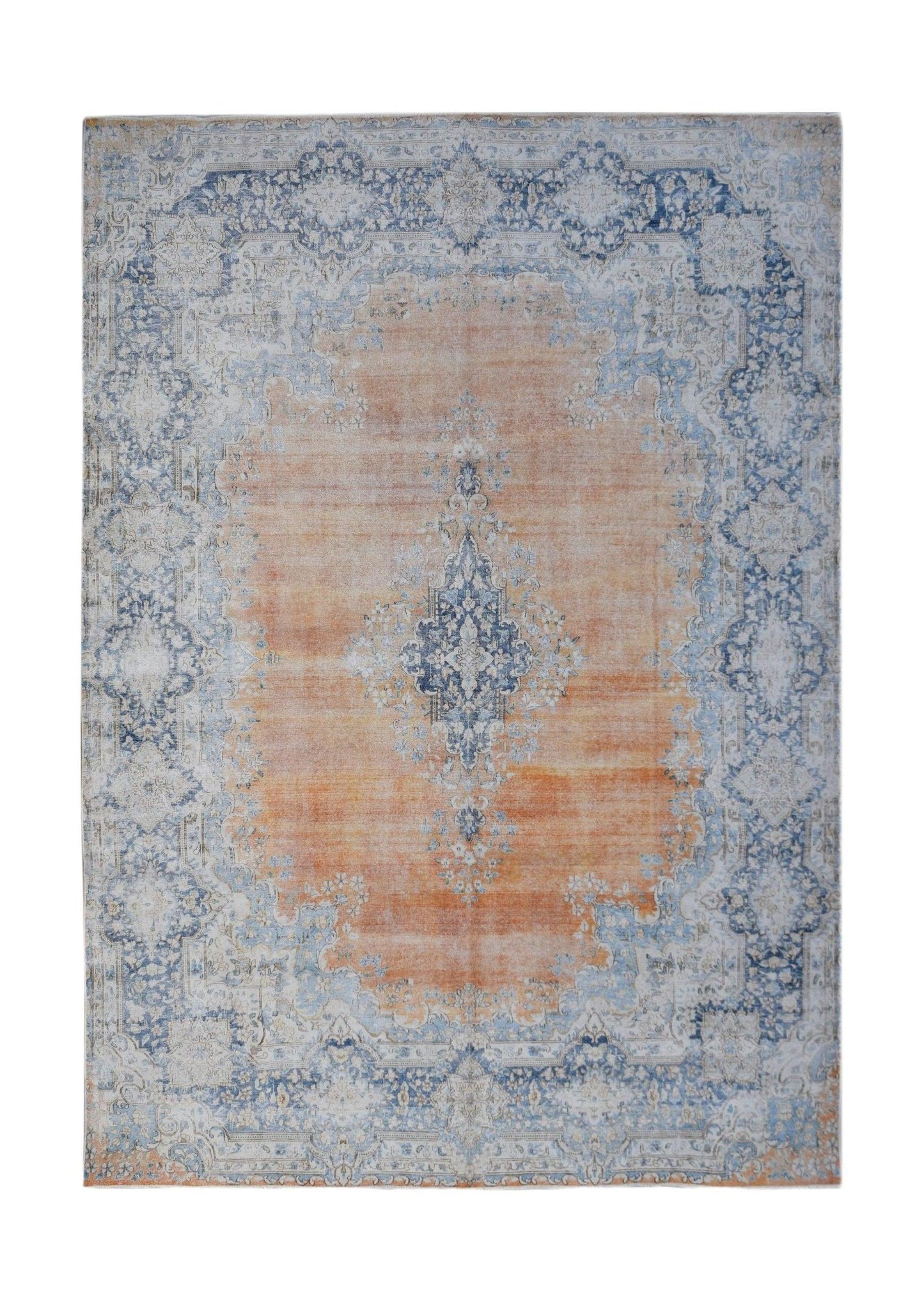 A vintage Persian Kerman rug featuring a central blue medallion on an orange field with floral motifs.