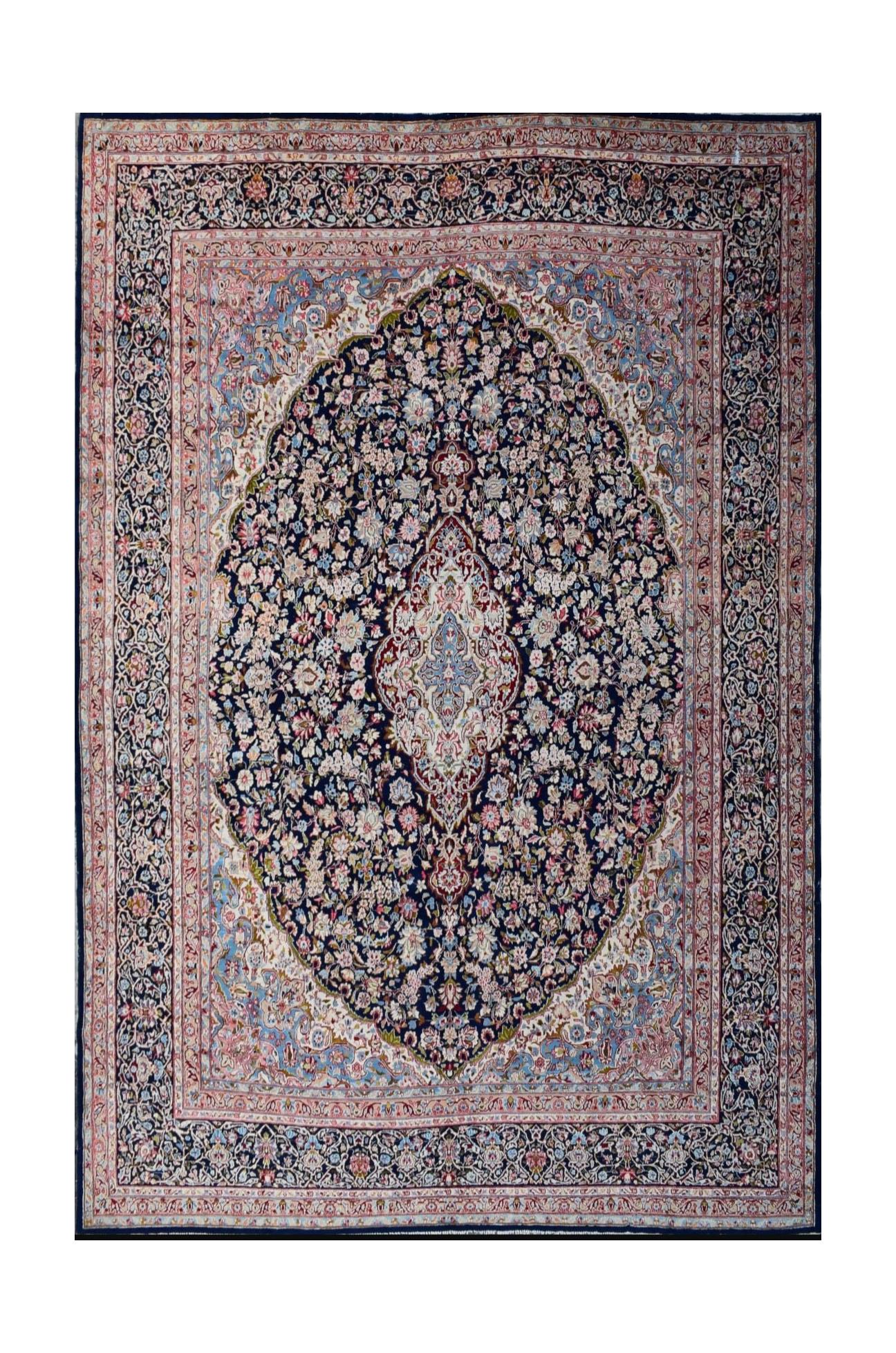 A vintage Persian Kerman rug featuring a central medallion and intricate floral patterns.