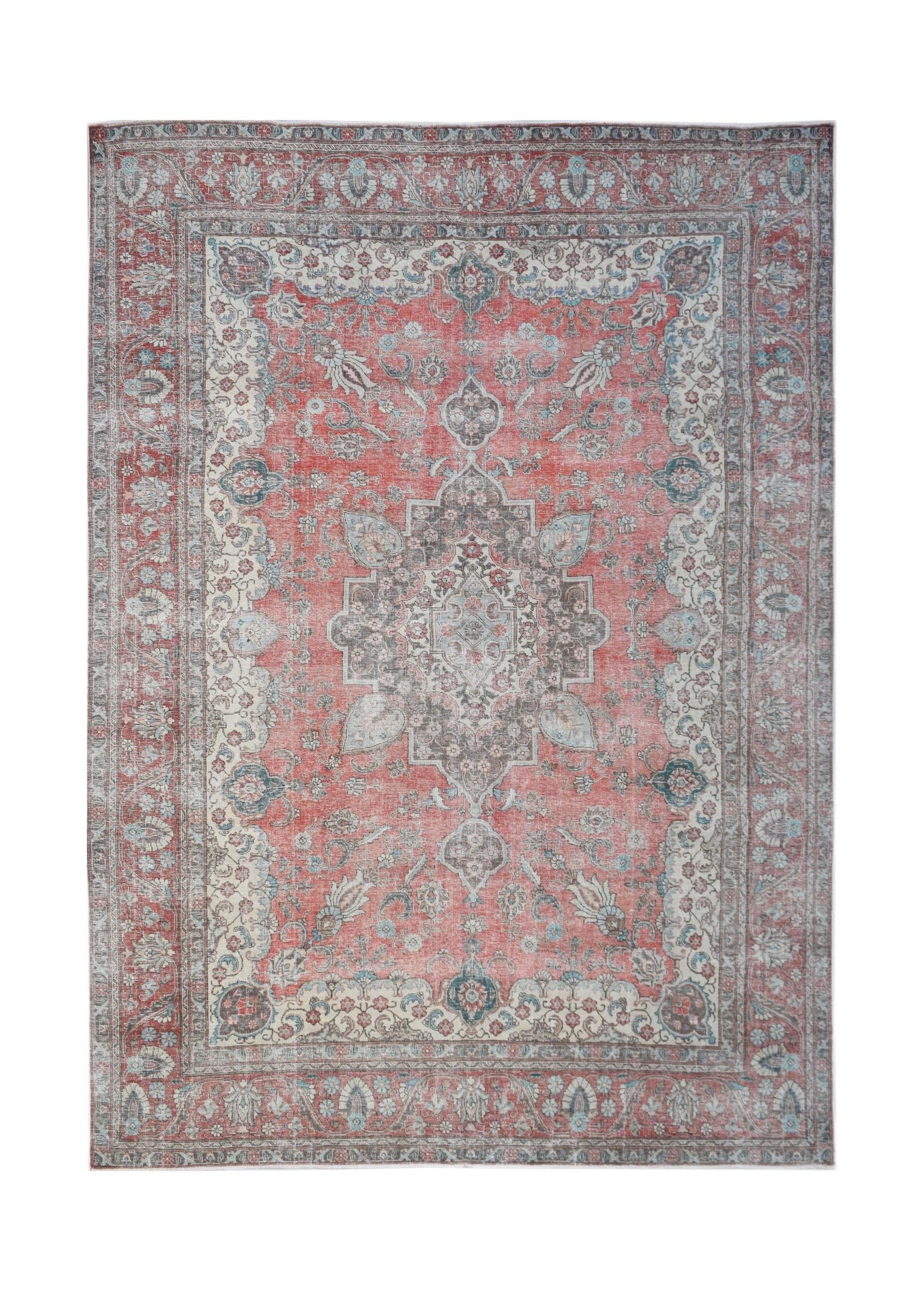 A vintage handwoven Persian Tabriz rug featuring a central floral medallion in red and grey tones.