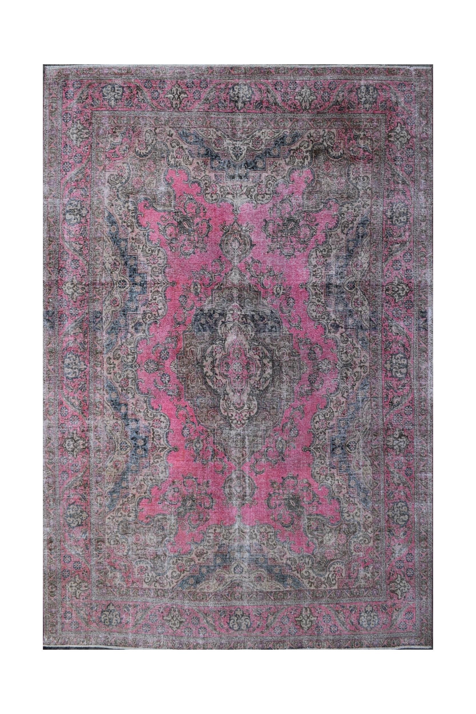 A vintage Persian Tabriz rug featuring intricate floral patterns in shades of pink and grey.