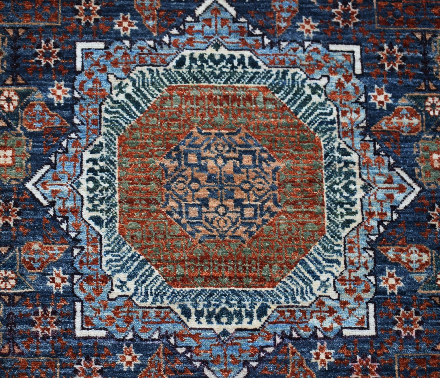 A handmade Afghan Balkh rug featuring a detailed Mamluk medallion pattern in blue, red, and green.