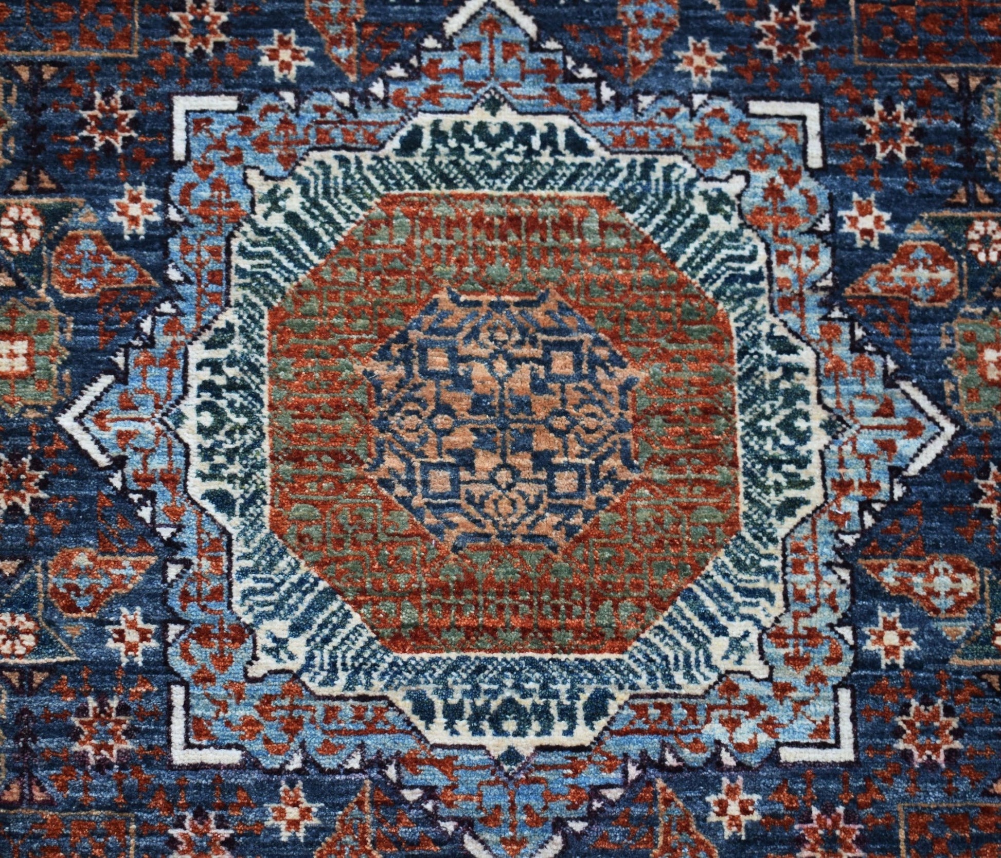 A handmade Afghan Balkh rug featuring a detailed Mamluk medallion pattern in blue, red, and green.