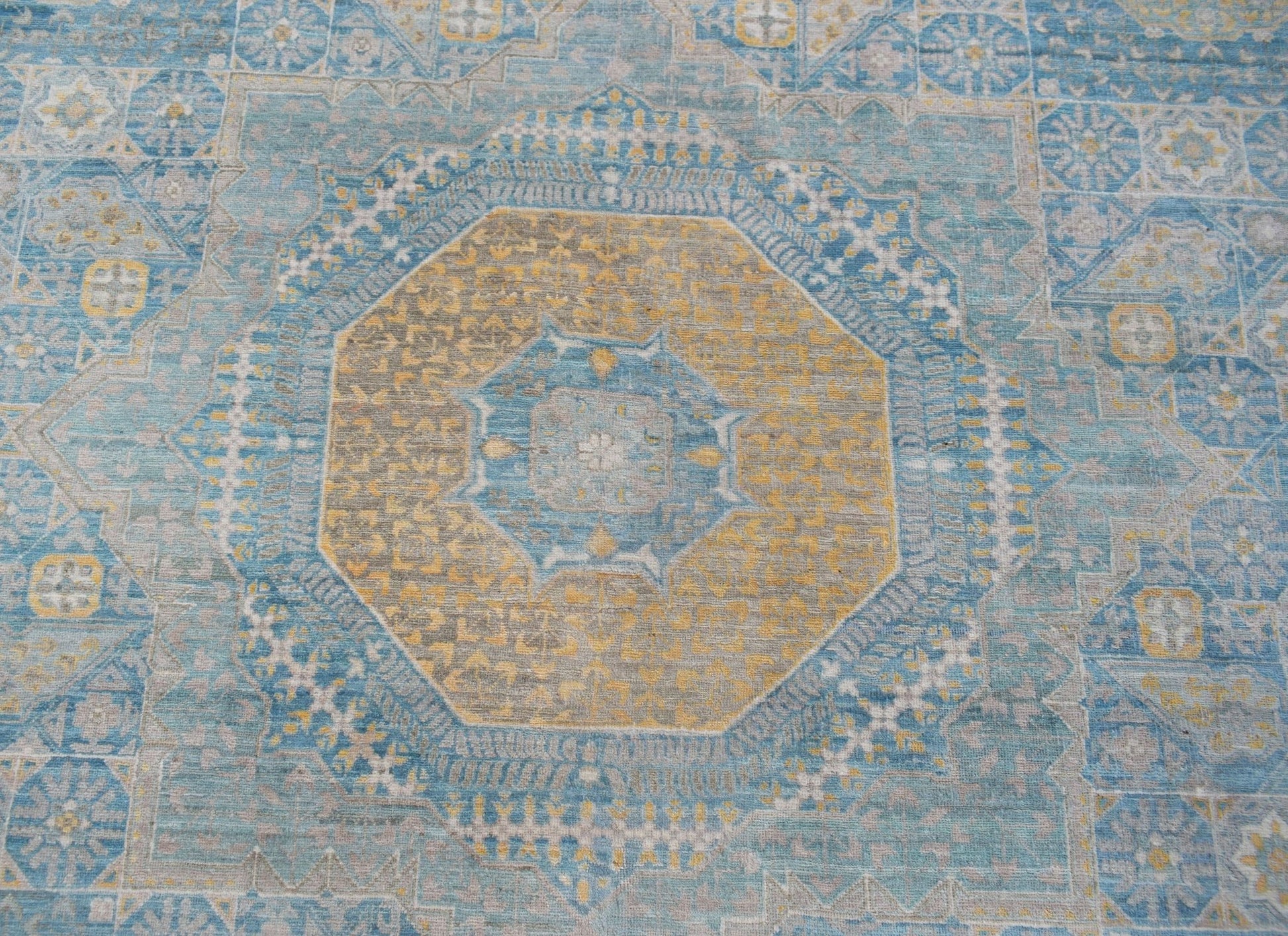 Handwoven Afghan Balkh rug featuring a detailed Mamluk medallion in blue and gold tones.