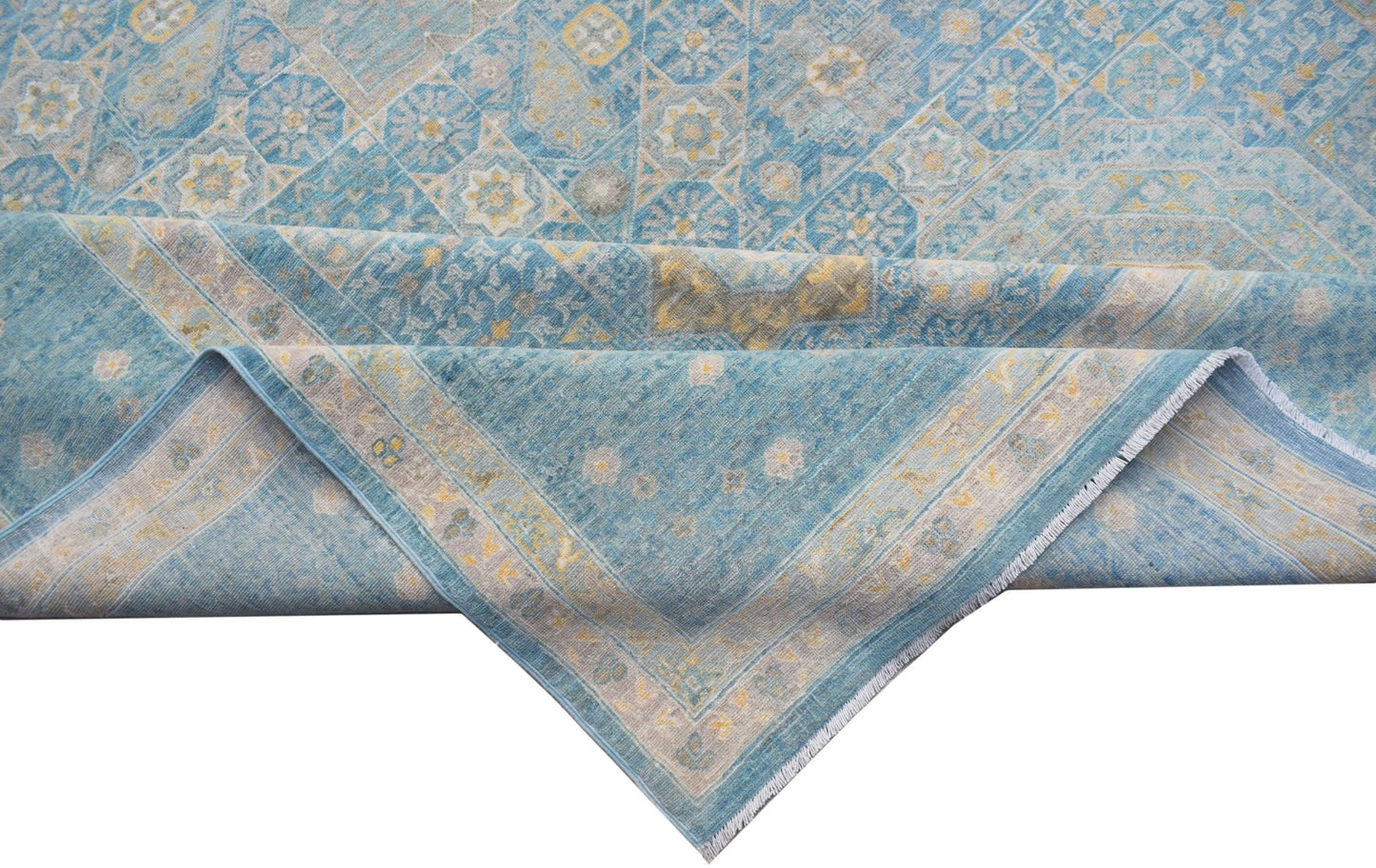 A handwoven Afghan Balkh rug featuring a blue Mamluk pattern with intricate geometric medallions.