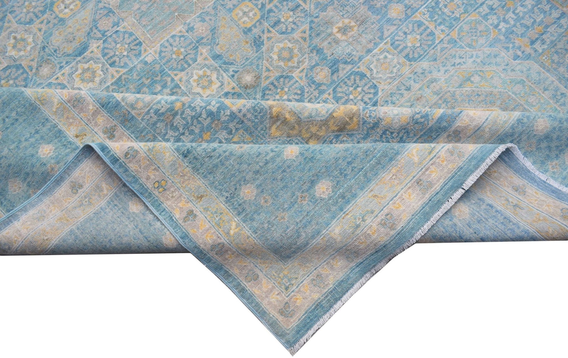 A handwoven Afghan Balkh rug featuring a blue Mamluk pattern with intricate geometric medallions.