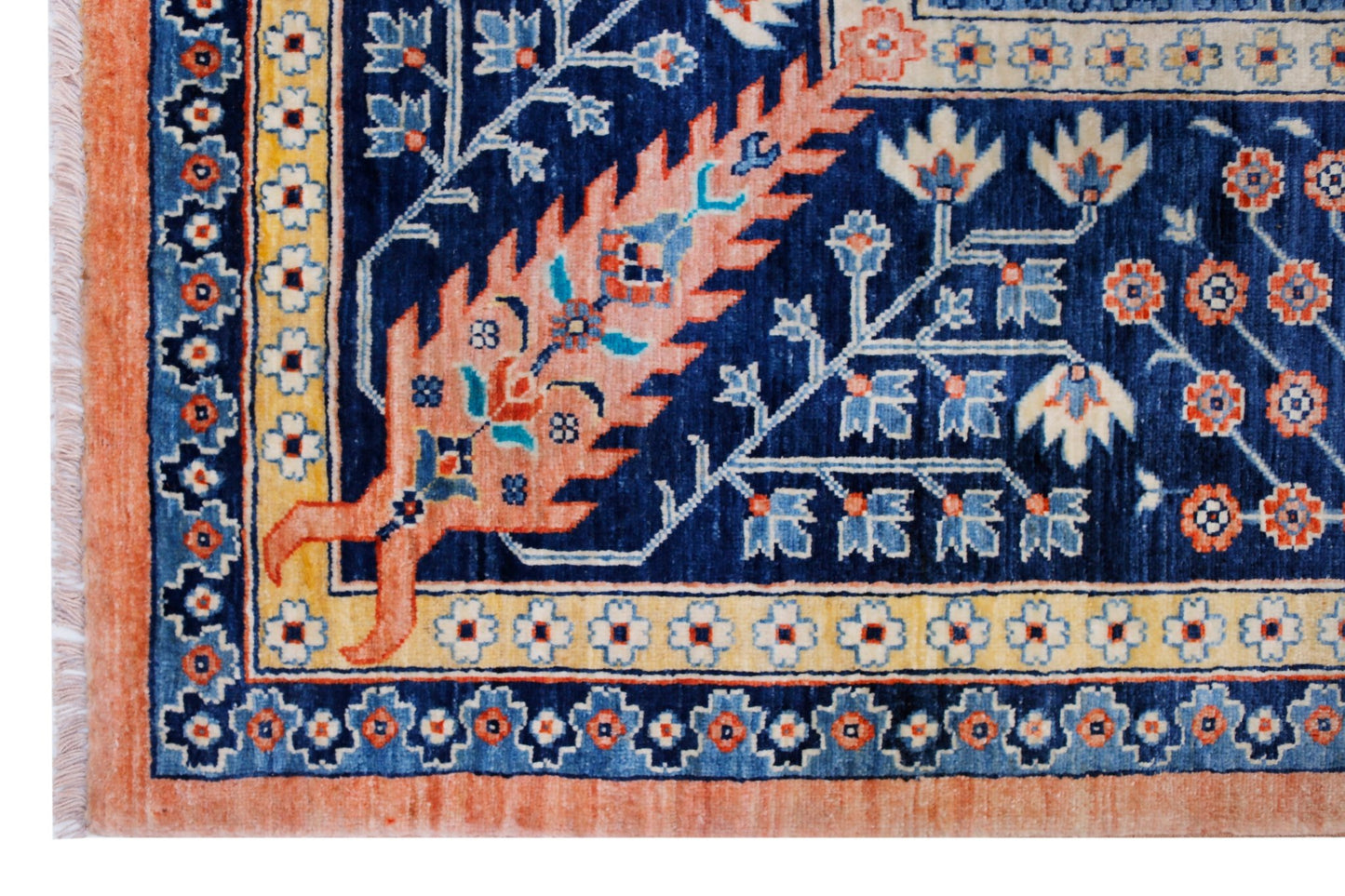 A handwoven Afghan Balkh rug featuring intricate floral patterns in blue, peach, and cream tones.