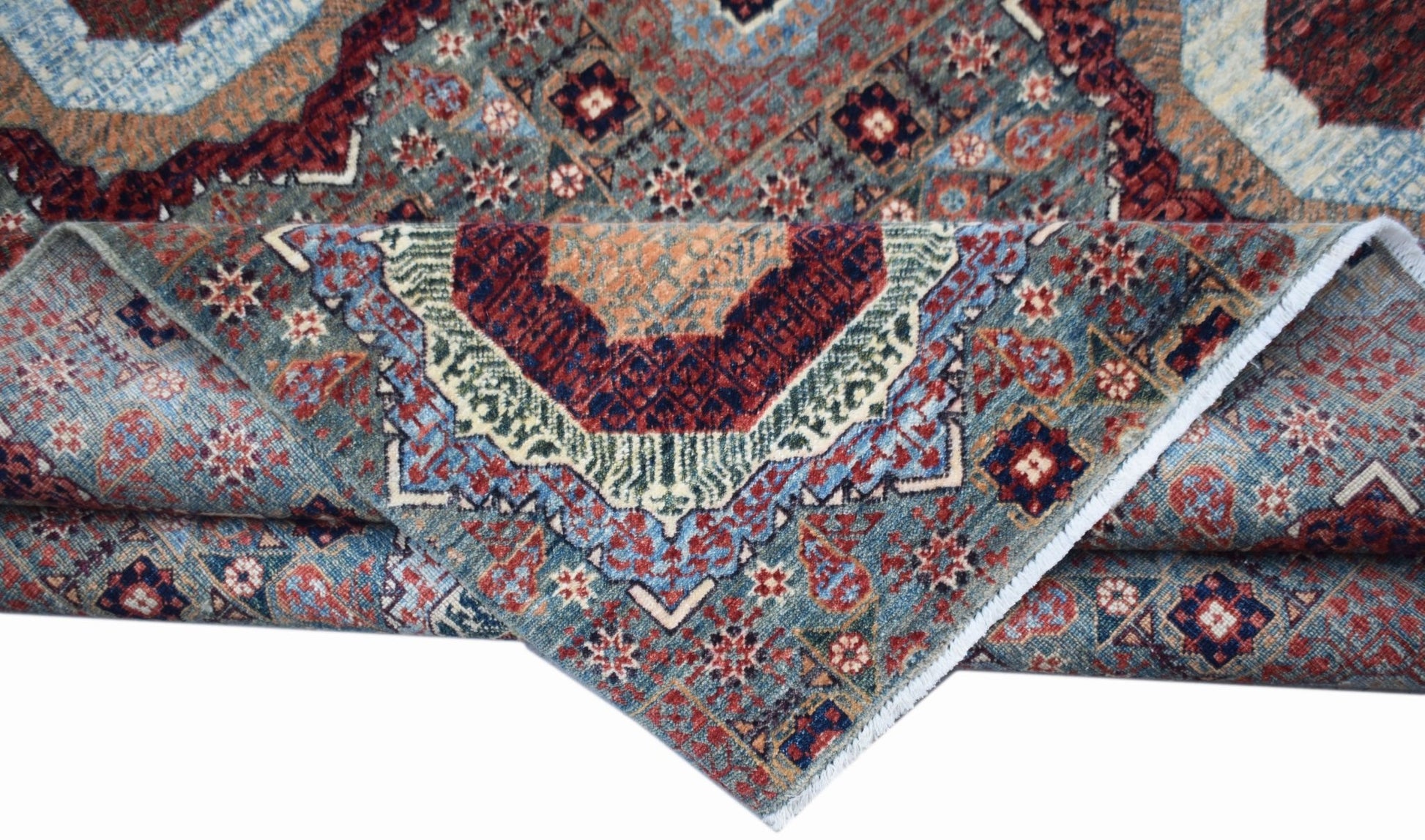 A handwoven Afghan Balkh rug featuring a detailed Mamluk medallion pattern in blue and red tones.