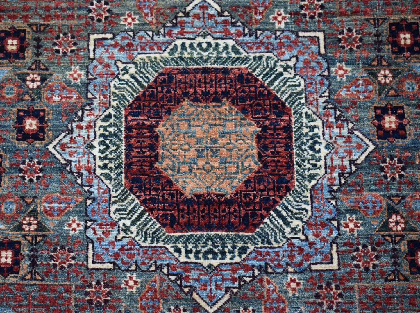 Handwoven Afghan Balkh rug featuring a detailed Mamluk medallion in blue, red, and tan tones.