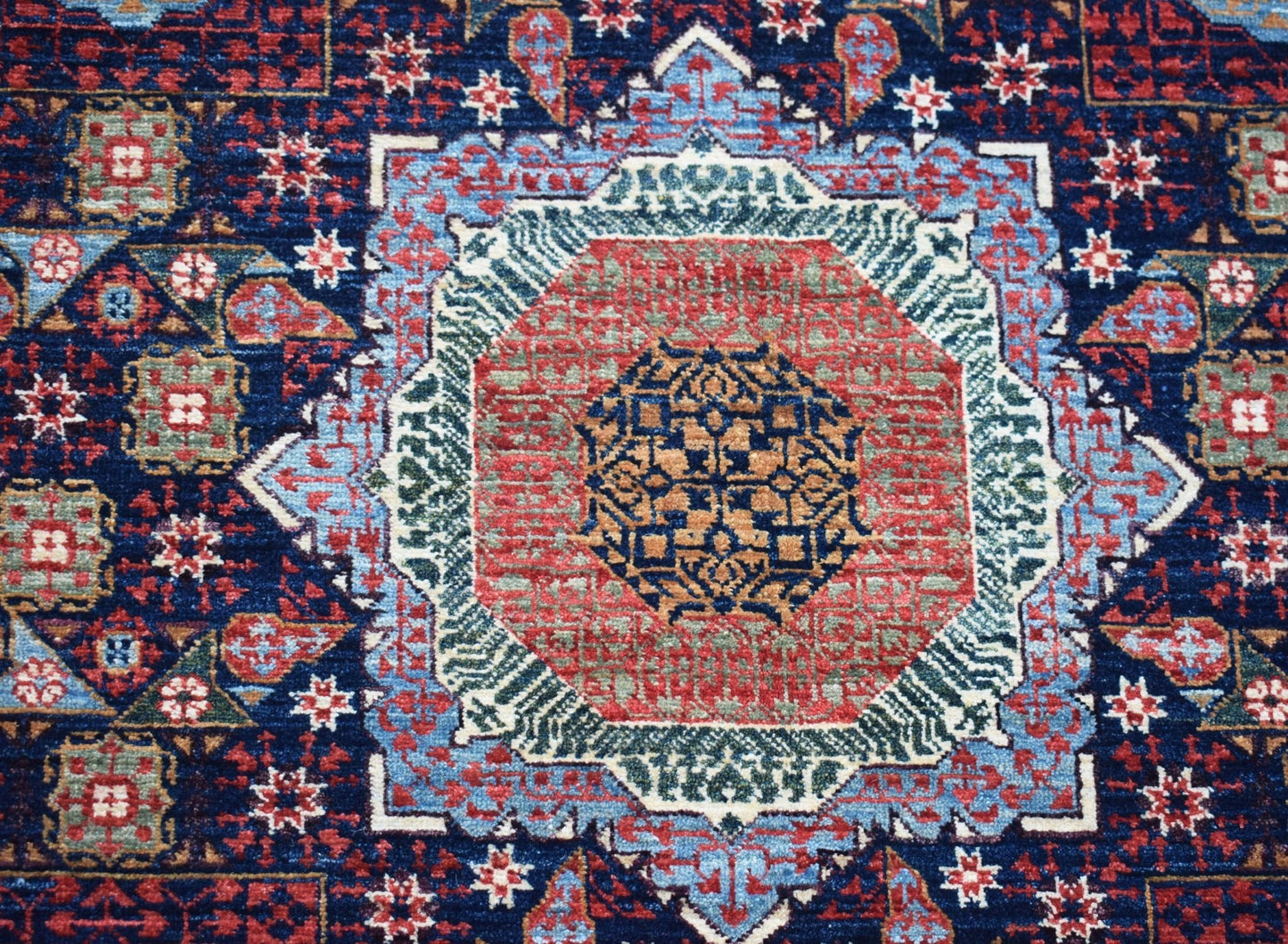 Handwoven Afghan Balkh rug featuring a detailed Mamluk medallion in red, blue, and gold tones.