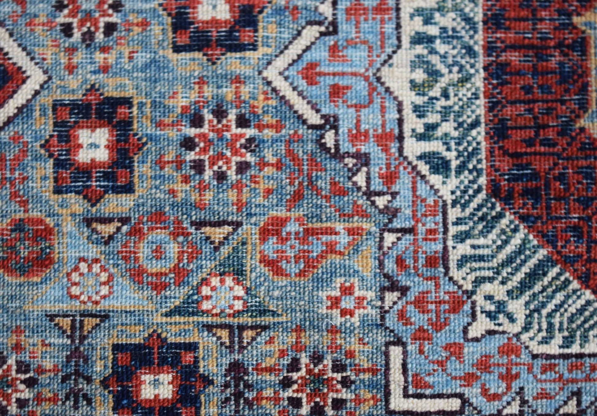 A handmade Afghan Balkh rug featuring a detailed blue, red, and cream Mamluk geometric pattern.