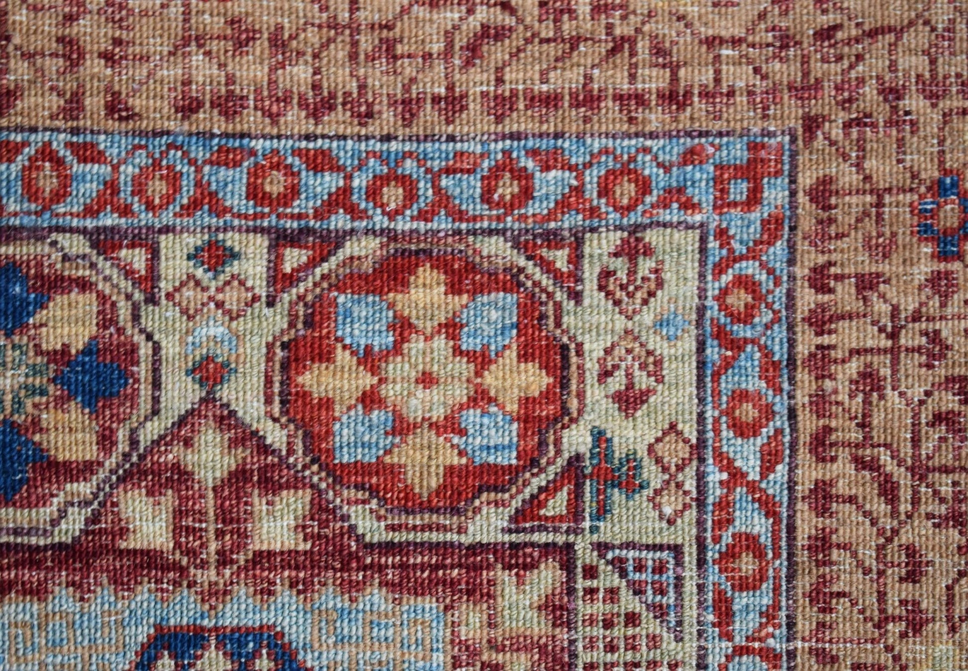 A close-up of a handmade Afghan Balkh rug featuring a detailed Mamluk medallion pattern.