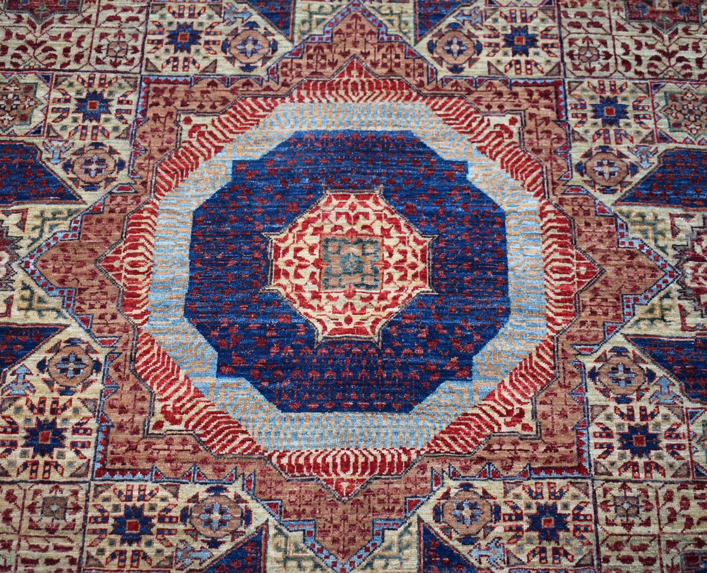 Handwoven Afghan Balkh rug featuring a traditional Mamluk medallion pattern in blue and red tones.