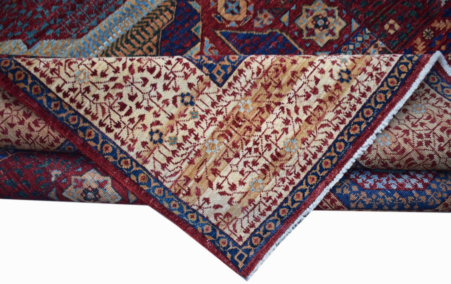 A handwoven Afghan Balkh rug featuring a complex Mamluk pattern in red, blue, and cream tones.