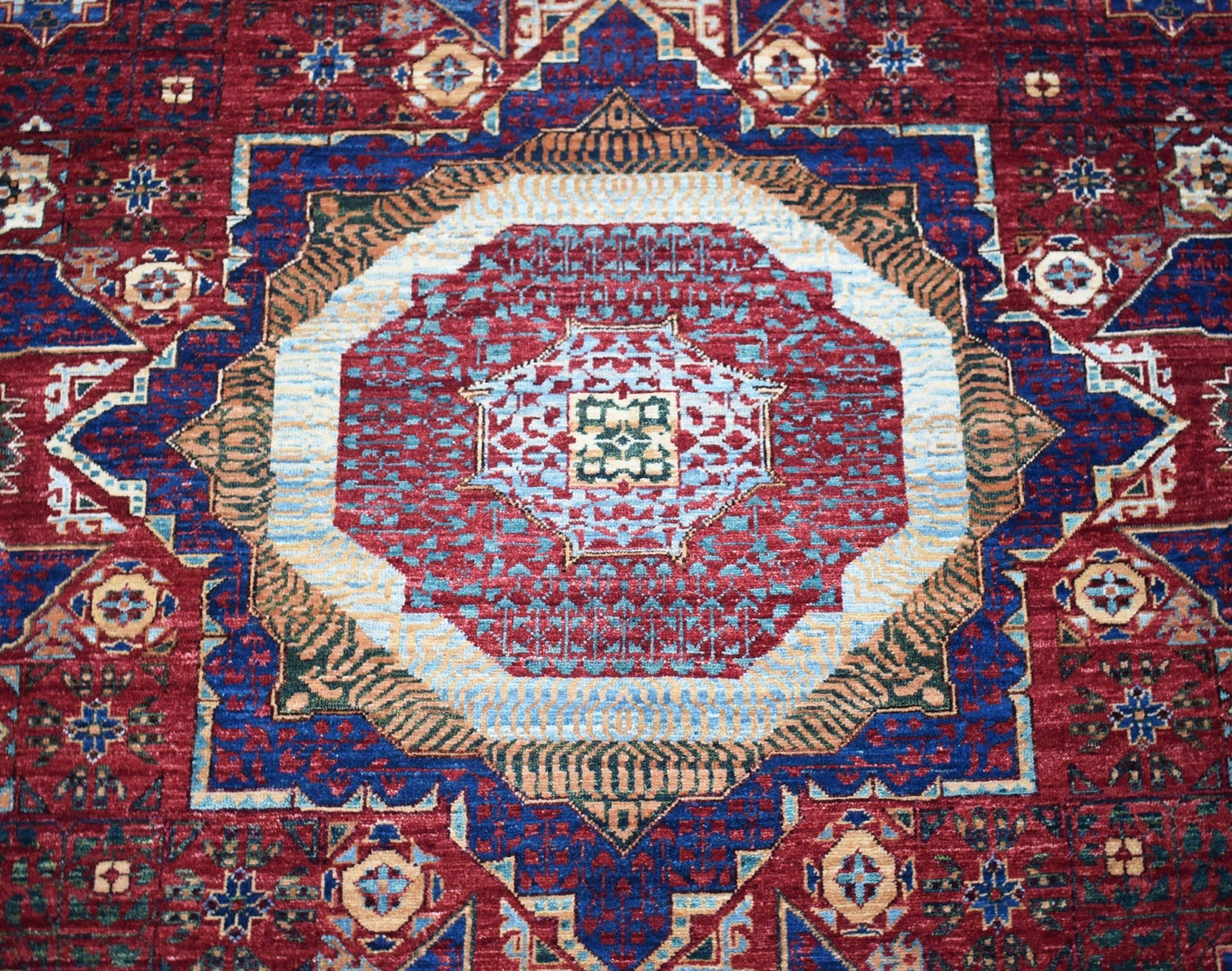 Handwoven Afghan Balkh rug featuring a detailed Mamluk medallion pattern in red and blue tones.