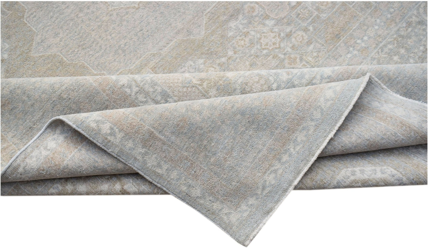 A handwoven Afghan Balkh rug in soft blue and beige tones with a traditional patterned design.