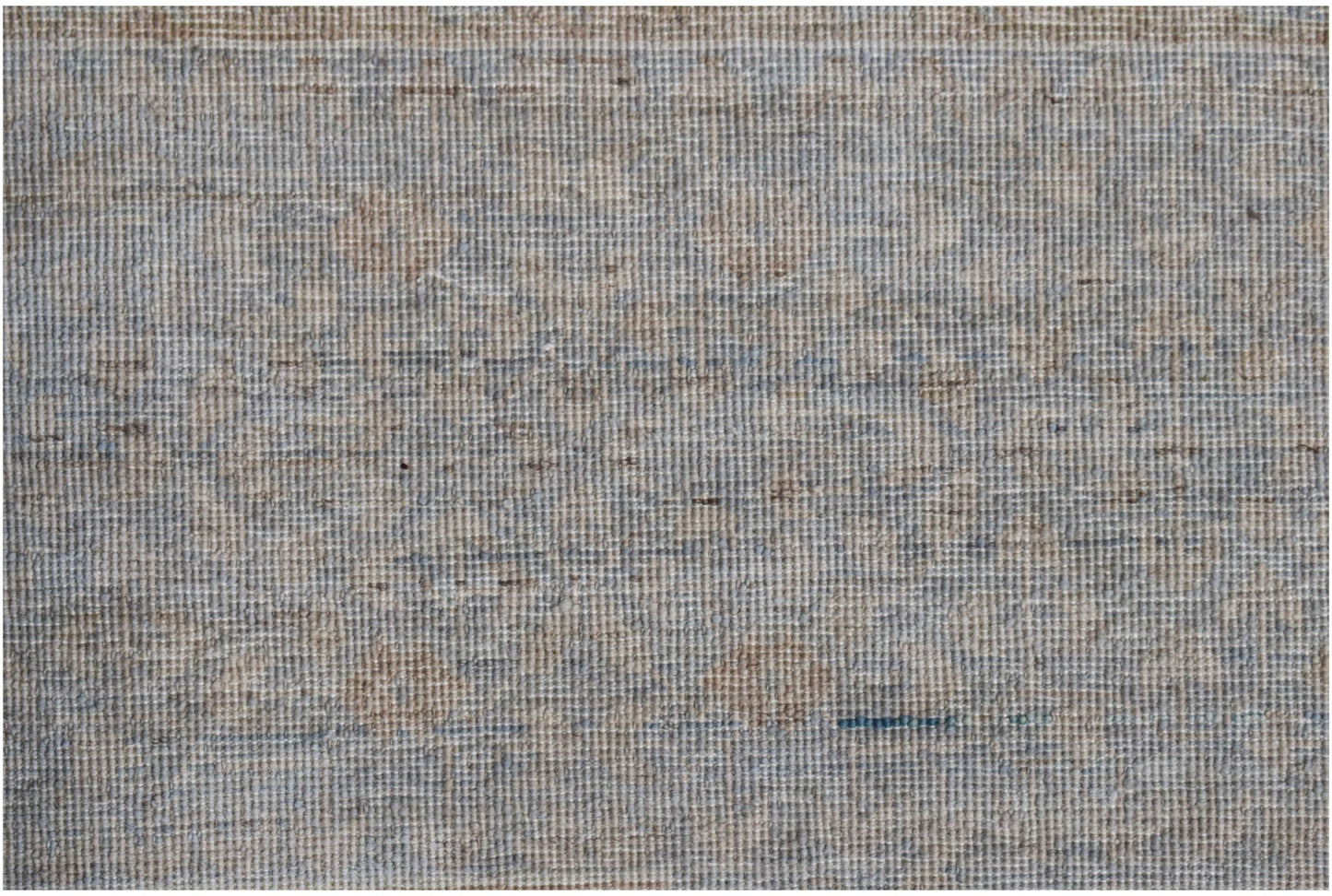 A handwoven Afghan Balkh rug featuring a textured, neutral pattern in shades of blue and beige.
