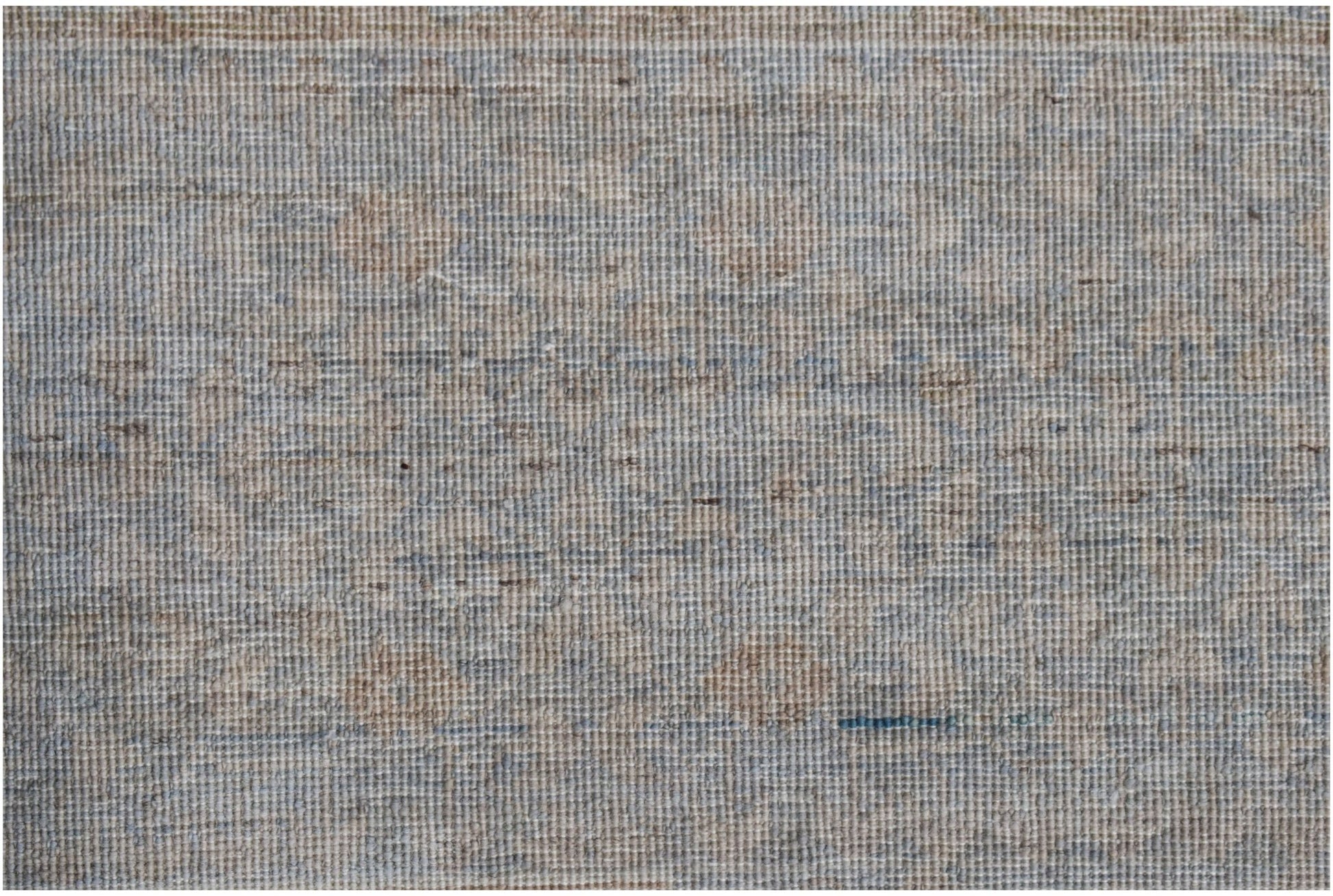 A handwoven Afghan Balkh rug featuring a textured, neutral pattern in shades of blue and beige.
