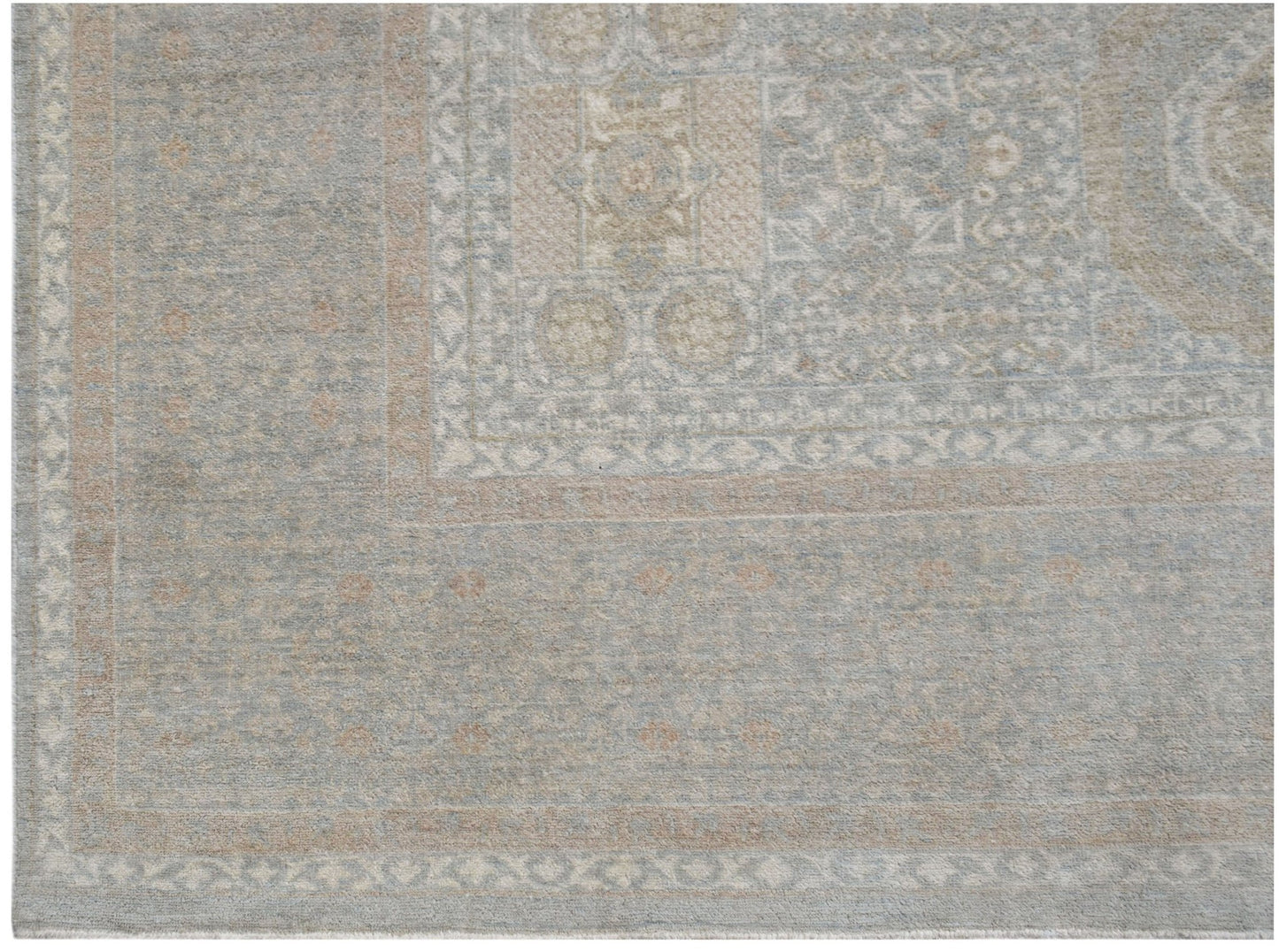 A handwoven Afghan Balkh rug featuring a traditional geometric pattern in soft blue and beige tones.