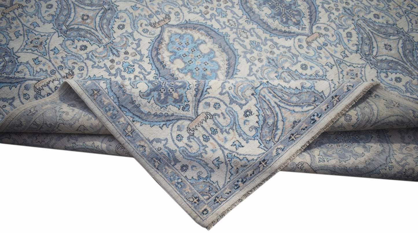 A handwoven Afghan Balkh rug featuring a traditional blue and cream floral pattern.