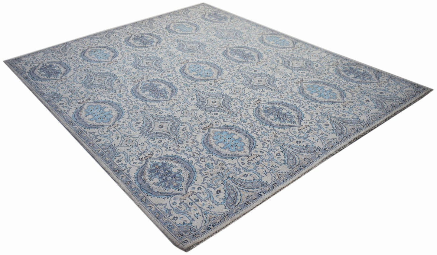 An Afghan Balkh rug featuring a traditional blue and cream floral pattern on hand-spun wool.