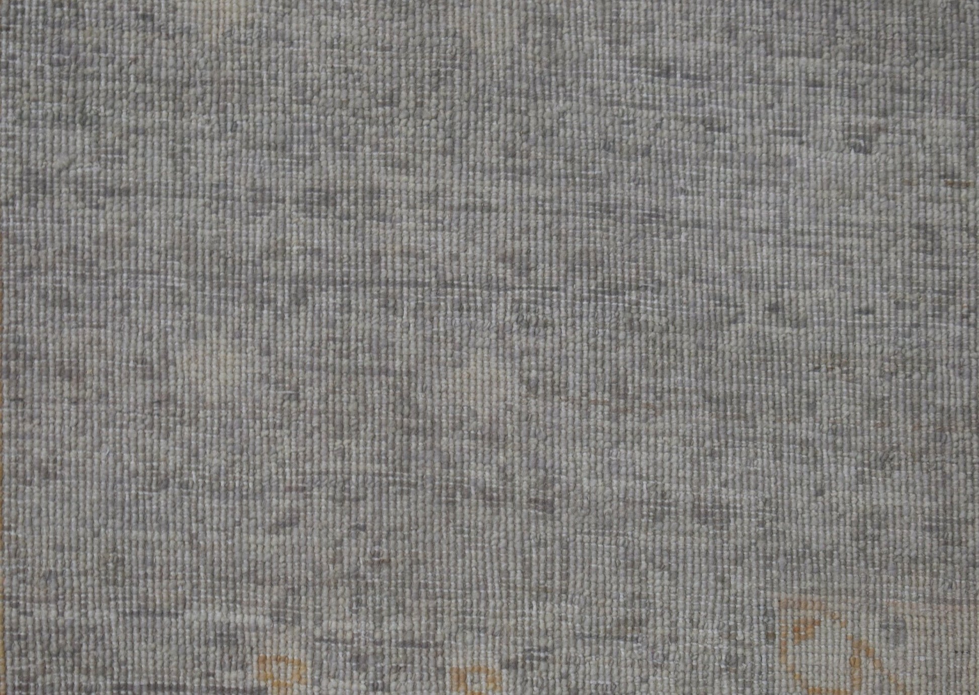 A handwoven Afghan Balkh rug featuring a textured, neutral grey wool pile with subtle variations.