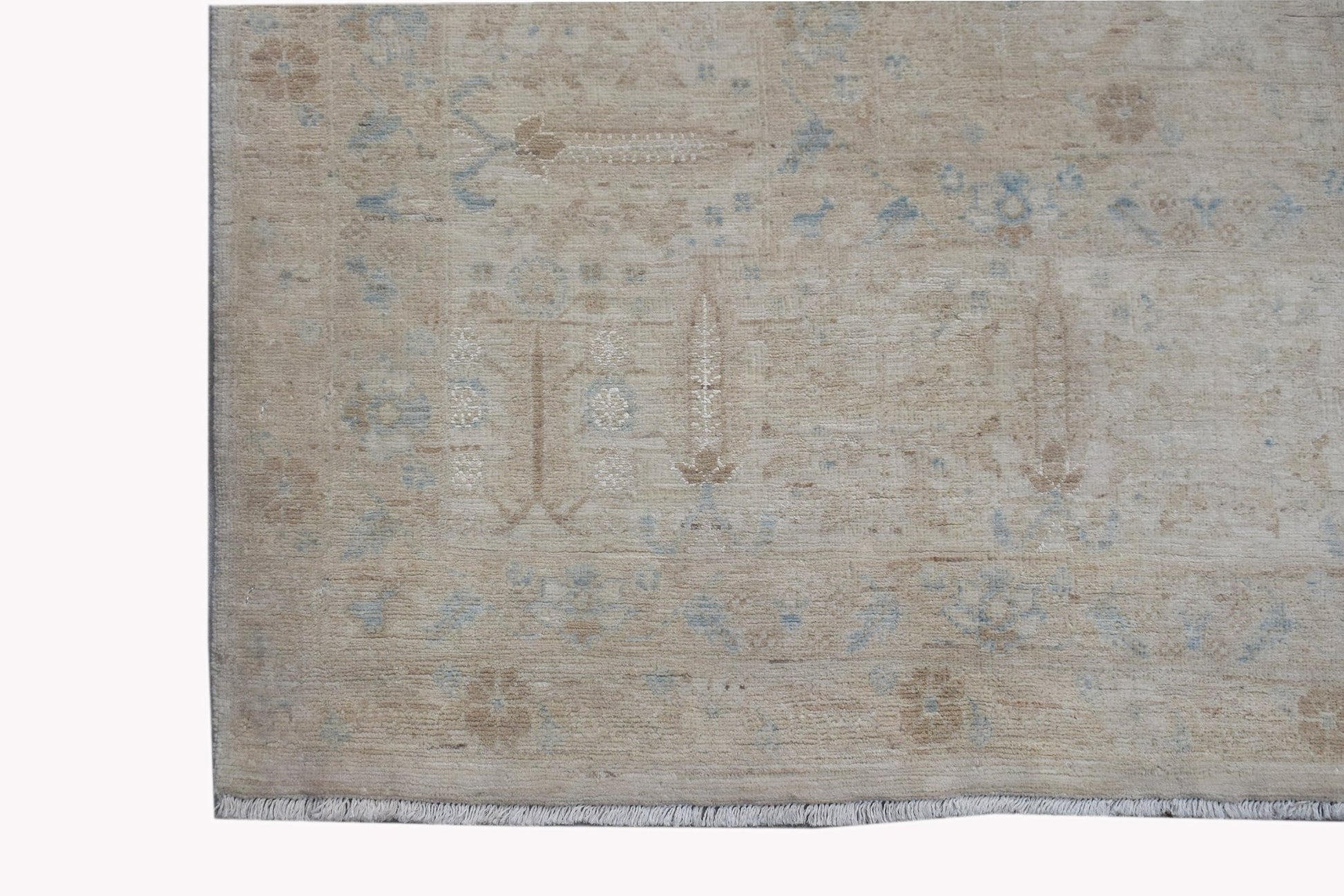 A handwoven Afghan Balkh rug featuring a traditional Chobi pattern in soft beige and blue tones.