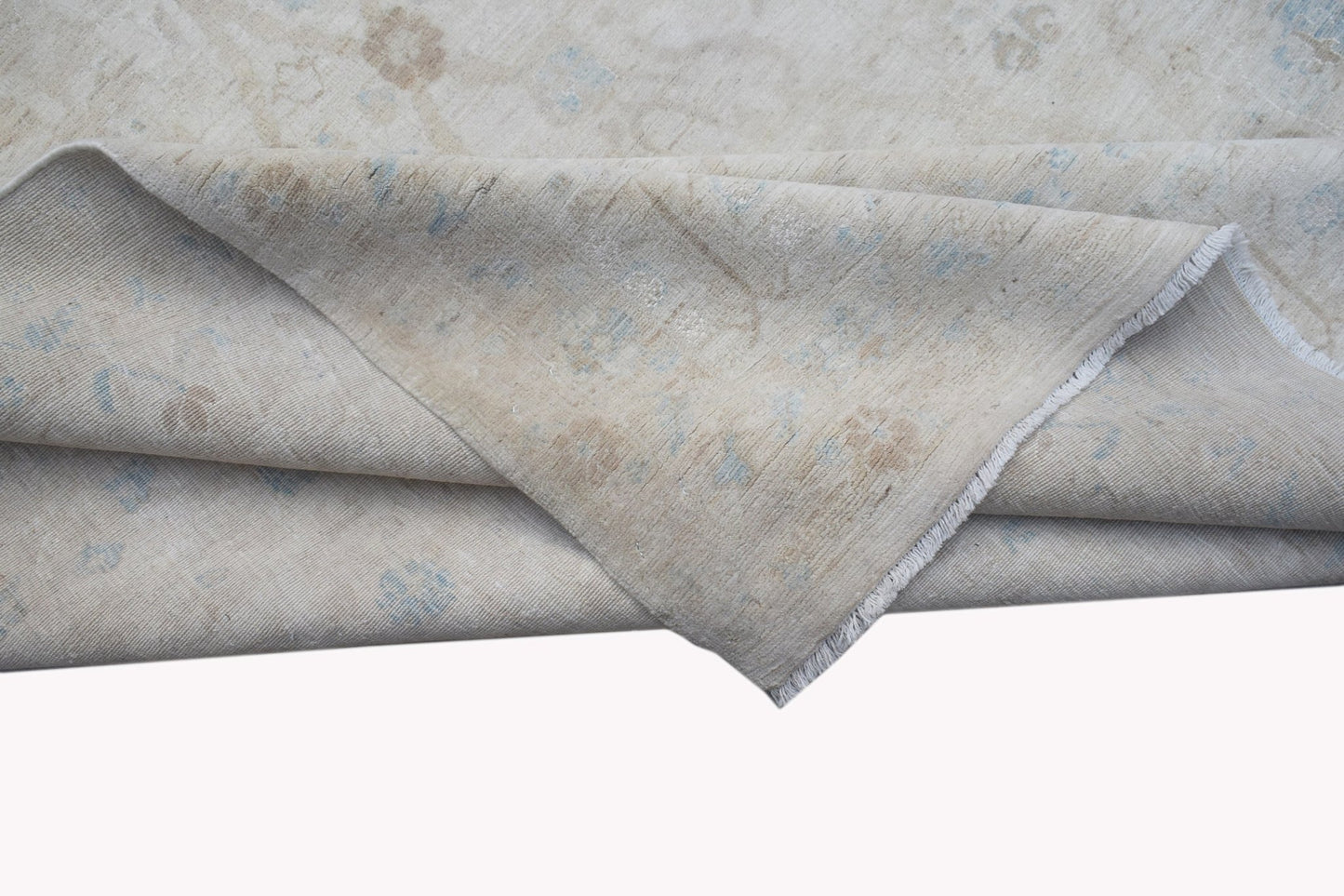 A handwoven Afghan Balkh rug featuring a neutral palette with subtle blue and beige floral motifs.