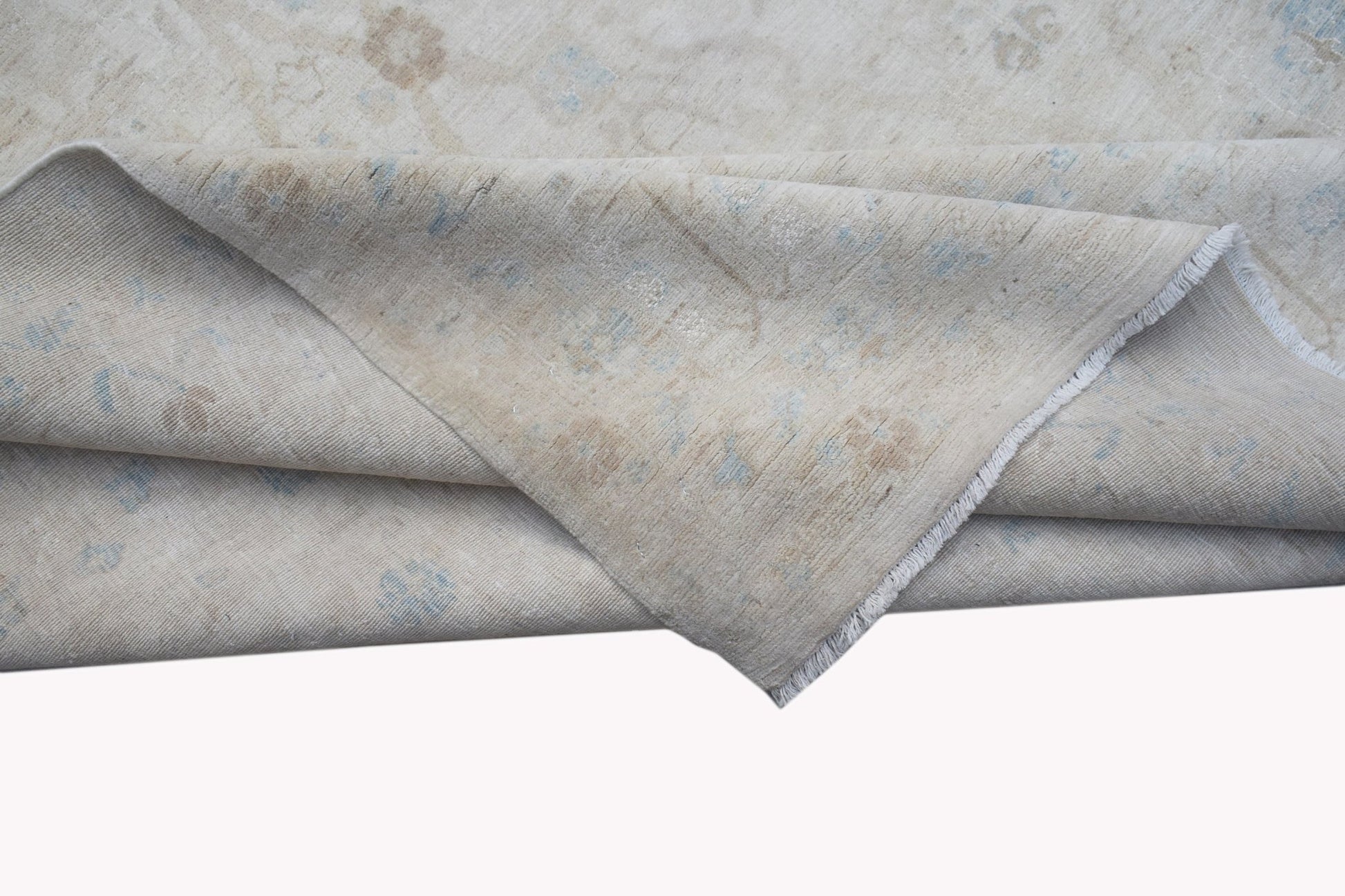 A handwoven Afghan Balkh rug featuring a neutral palette with subtle blue and beige floral motifs.