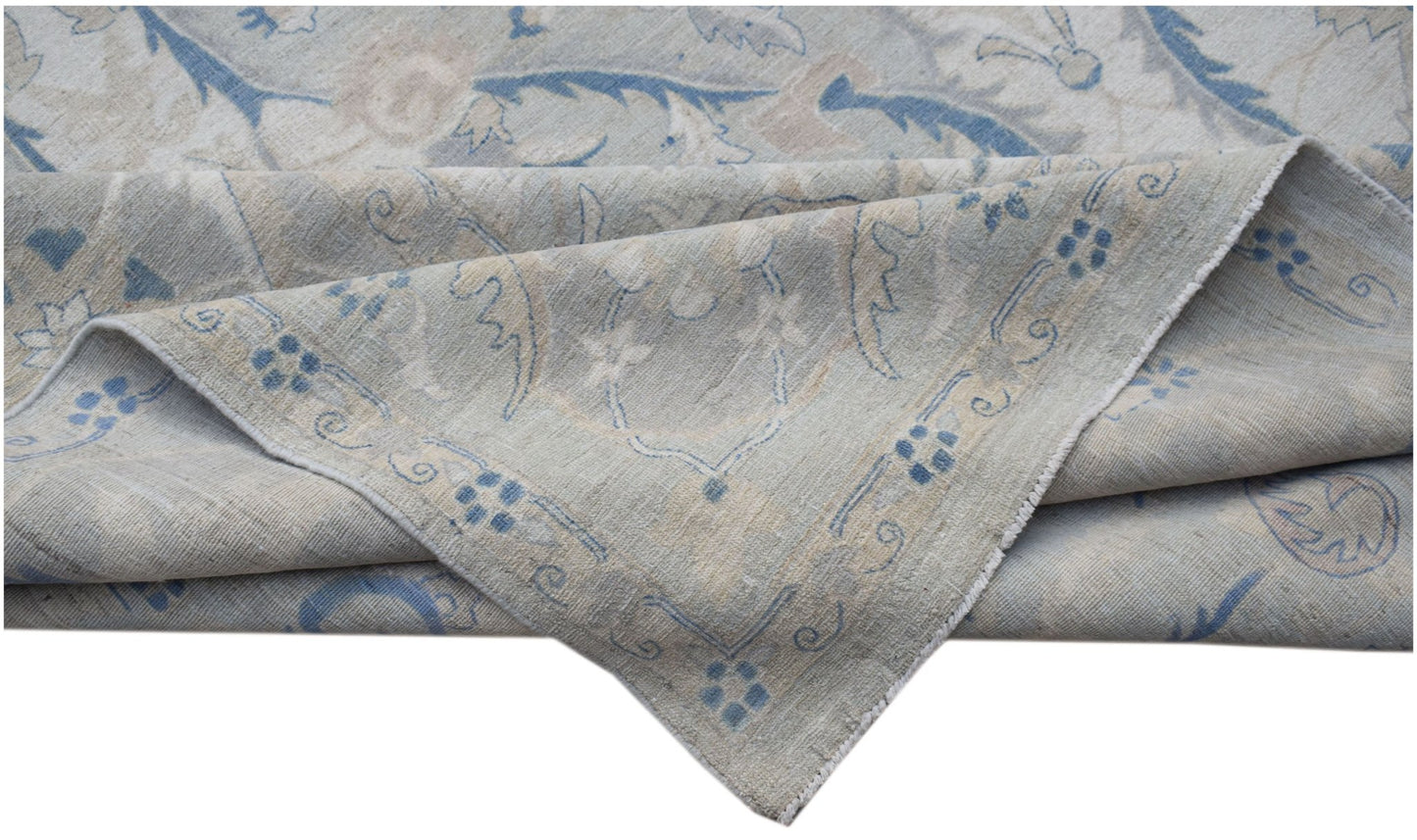 A handwoven Afghan Balkh rug featuring a traditional floral pattern in soft blue and beige tones.