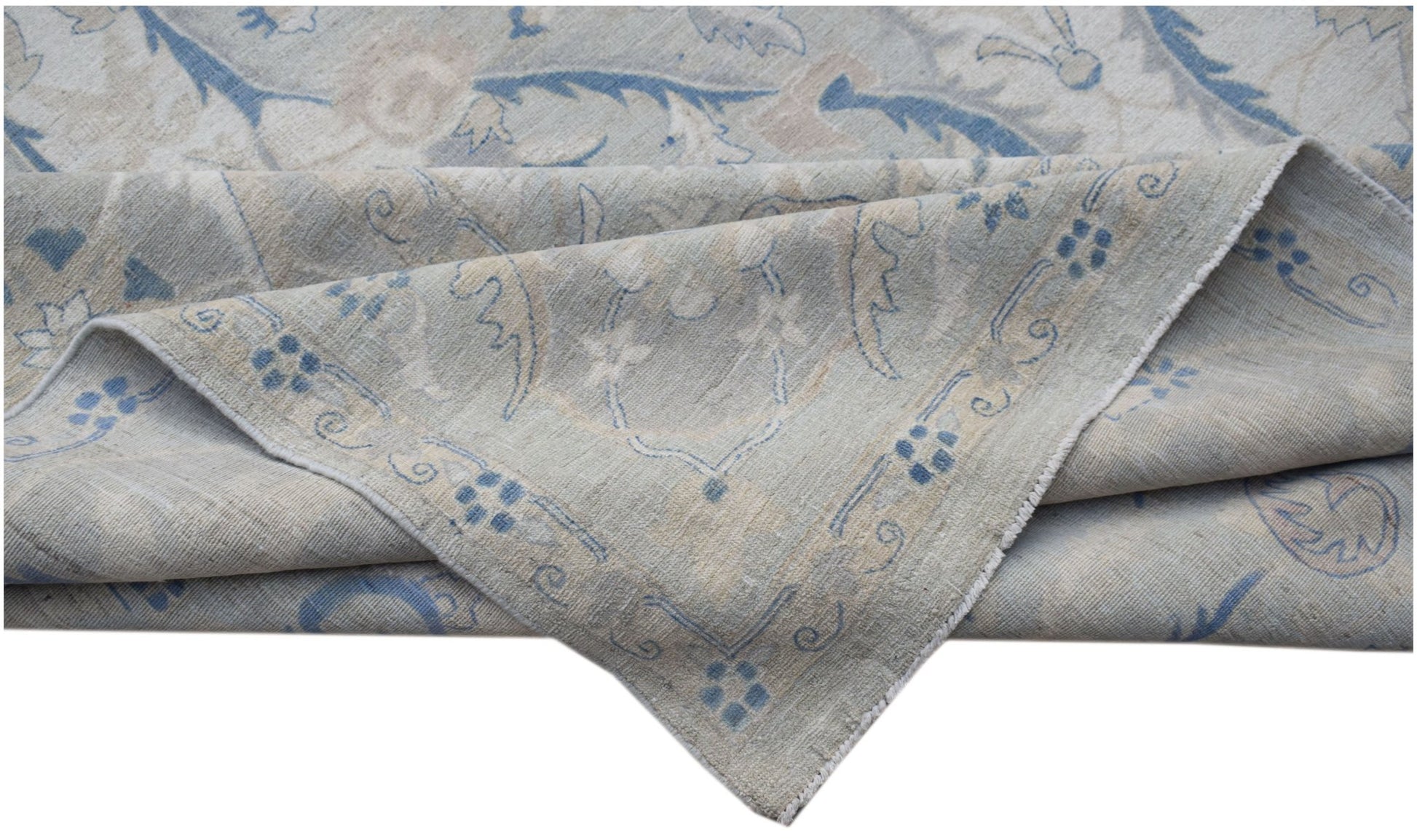 A handwoven Afghan Balkh rug featuring a traditional floral pattern in soft blue and beige tones.