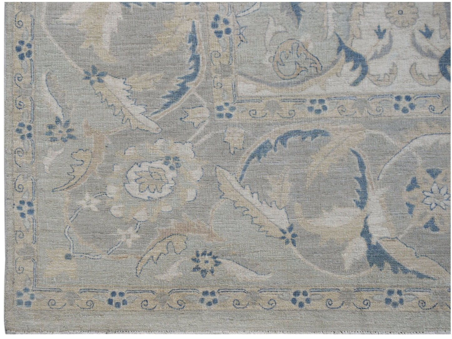 Handwoven Afghan Balkh rug featuring a traditional floral pattern in soft blue and beige tones.