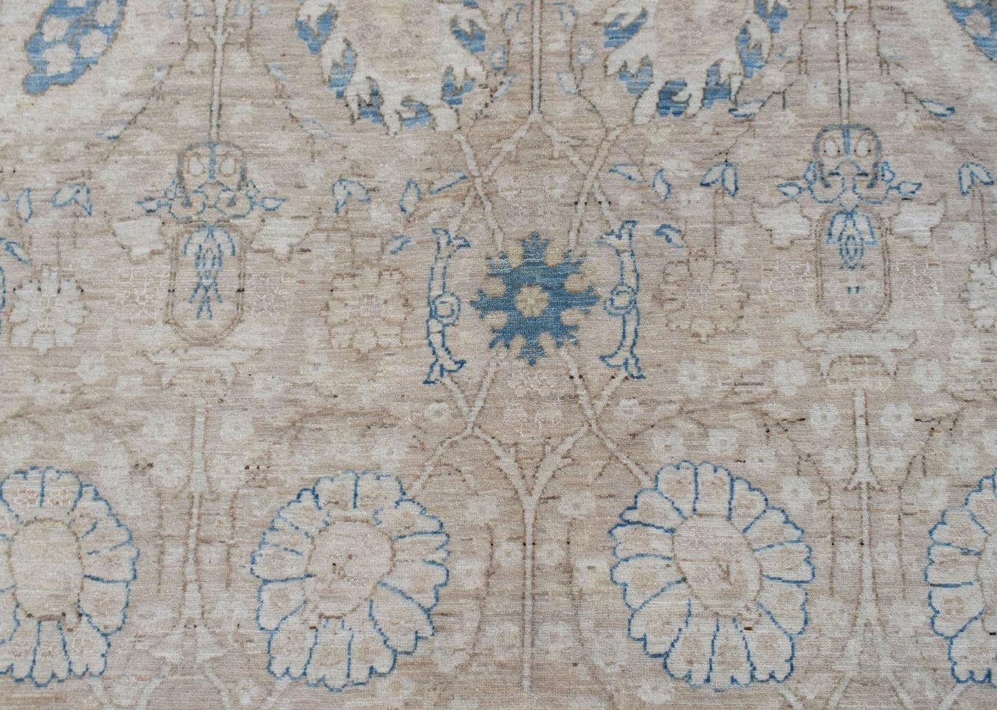 Handwoven Afghan Balkh rug featuring a traditional floral pattern in blue and beige tones.