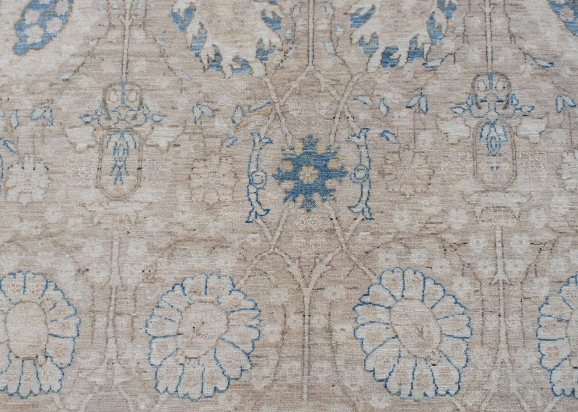 Handwoven Afghan Balkh rug featuring a traditional floral pattern in blue and beige tones.
