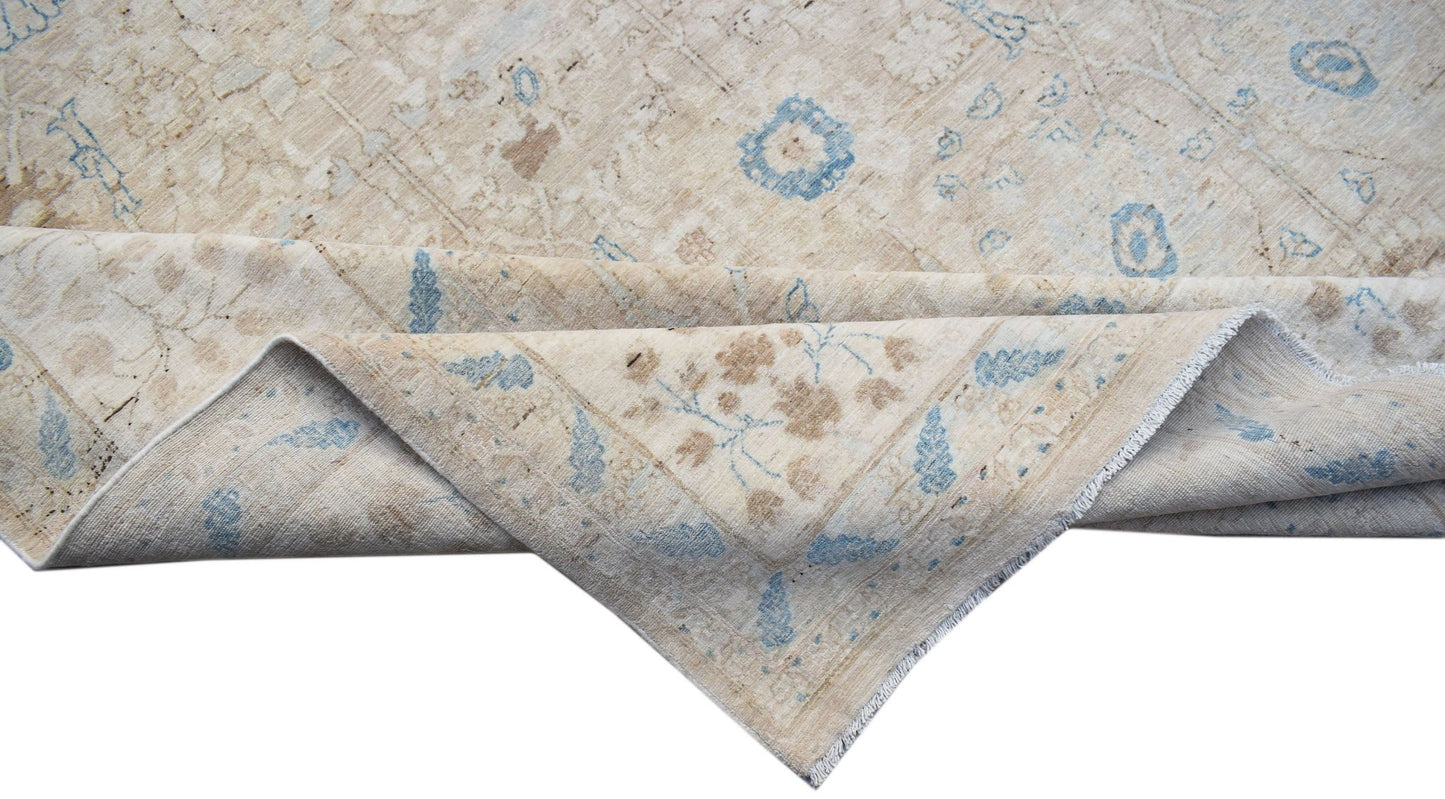 A handwoven Afghan Balkh rug featuring a traditional floral pattern in beige and soft blue tones.