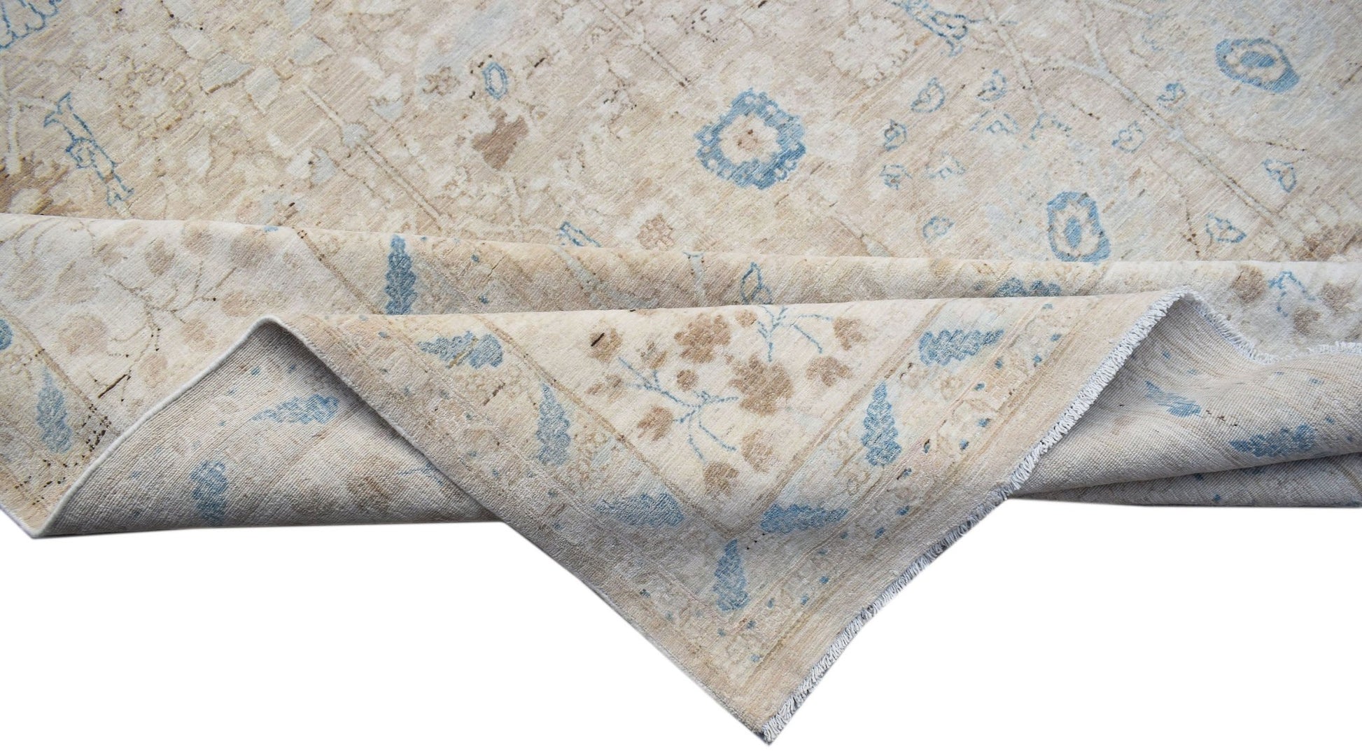 A handwoven Afghan Balkh rug featuring a traditional floral pattern in beige and soft blue tones.