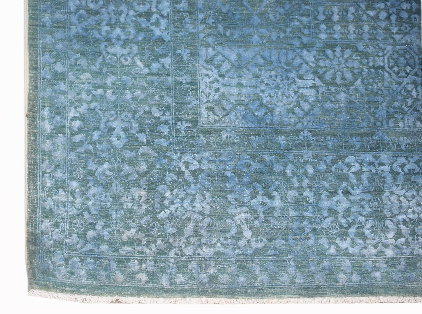 A handwoven Afghan Balkh rug featuring a detailed blue Mamluk pattern with a fringed edge.