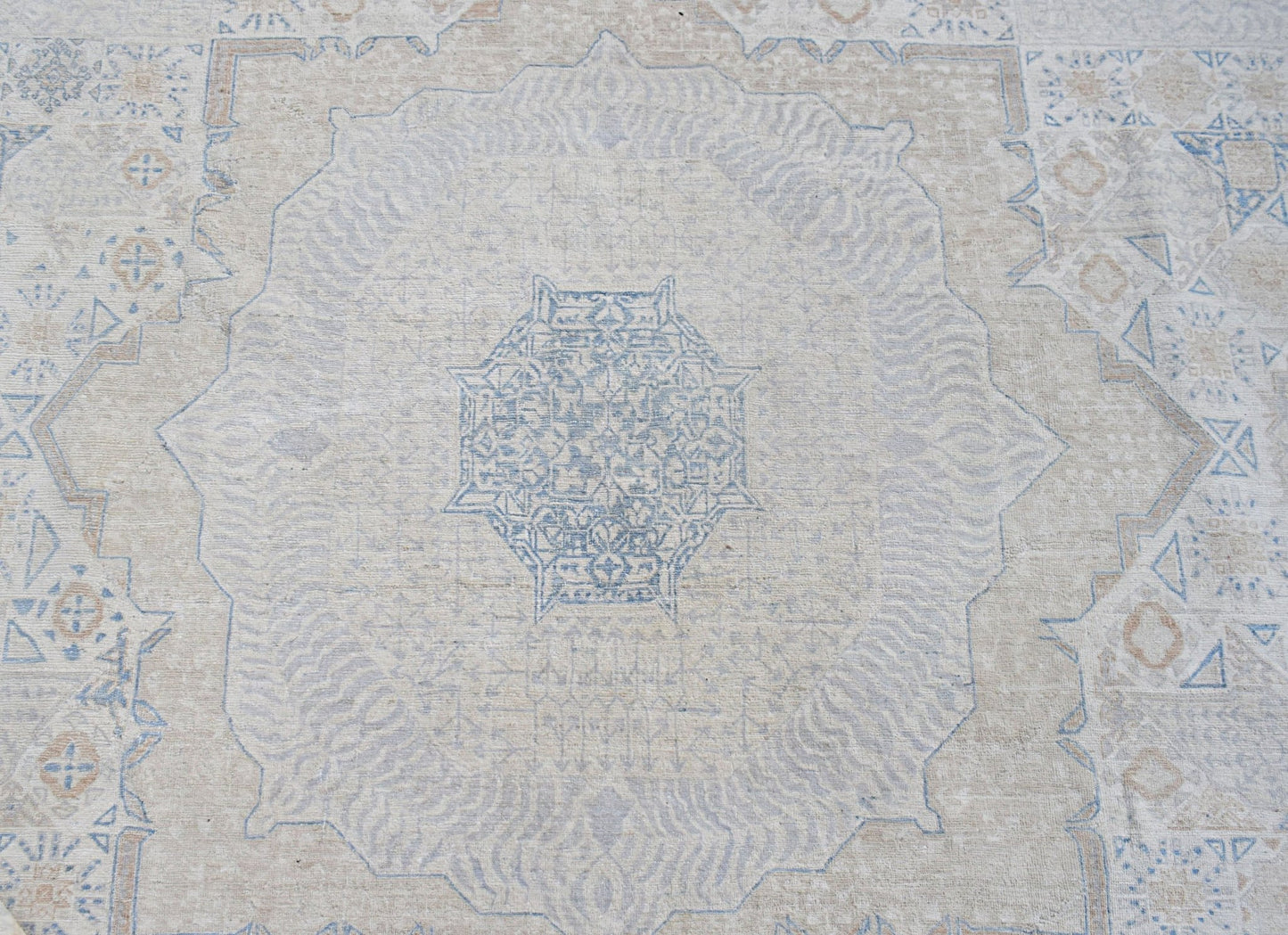 Handwoven Afghan Balkh rug featuring a detailed blue Mamluk medallion on a neutral wool background.